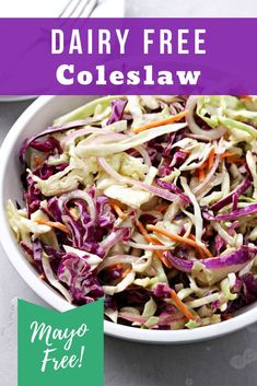 a white bowl filled with coleslaw on top of a table next to a fork