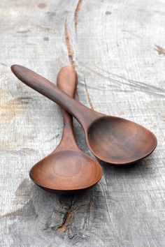 two wooden spoons sitting on top of each other