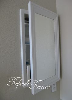 a white medicine cabinet sitting next to a wall mounted mirror