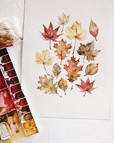 an image of leaves painted in watercolor on paper with paintbrushes next to it