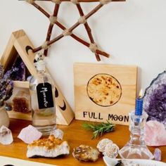 a table topped with lots of different types of rocks and bottles on top of it