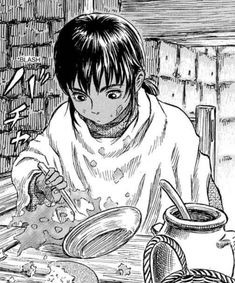 a boy sitting at a table with food in front of him