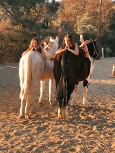 two women riding on the backs of horses