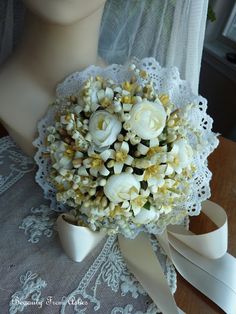 a bridal bouquet with white flowers on a mannequin