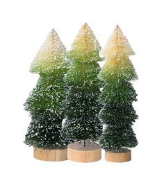 three small trees are sitting in wooden vases with snow on them and one is yellow