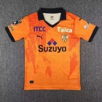 an orange soccer jersey with black trim on the chest