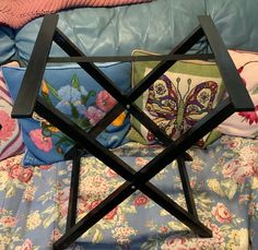 a wooden star shaped tray on top of a bed