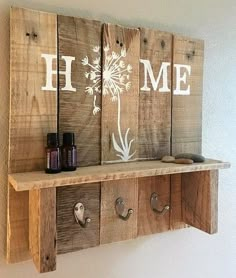 a wooden shelf with some bottles and hooks on it that have dandelion painted on them