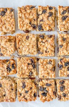 homemade granola bars cut into squares and placed on top of each other with raisins