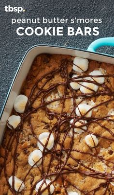 a cookie bar with marshmallows and chocolate drizzle