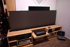 the entertainment center is made out of wood and has electronic equipment on top of it