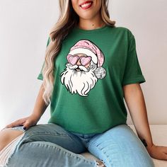 Disco Santa Shirt, Pink Santa Shirt, Preppy Christmas T-Shirt, Funny Holiday Outfit, Retro Hippy Santa Shirt for Christmas ----------- How to Order Your Custom Design T-shirt ---------- * Choose your t-shirt color * Choose your size * PLEASE make sure all your order's steps ---------- Product ---------- * 4.2 oz., 100% airlume combed and ringspun cotton, 32 singles * 32 singles Athletic Heather and Black Heather are 90/10 airlume combed and ringspun cotton/polyester Ash is 99/1 airlume combed and ringspun cotton/polyester * double-needle stitching throughout * seamless collar * heat transfer label * taped shoulder-to-shoulder Tell us what you want in the Message Box that's hidden in the Review Page during Checkout. Please use "ADD MESSAGE TO SELLER" icon before you checkout HINT: Click the Outfit Retro, Pink Santa, Preppy Christmas, Santa Shirt, Funny Holiday, Santa Shirts, Holiday Humor, Holiday Outfit, Christmas T Shirt