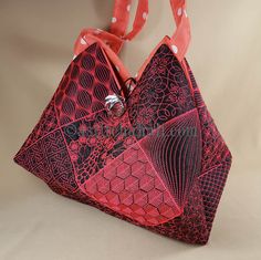 a red and black handbag on a white background