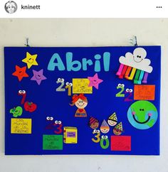 a blue bulletin board with colorful magnets on it