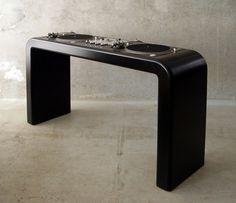 a black table sitting on top of a white floor