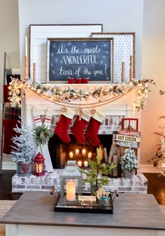 a fireplace decorated for christmas with stockings and candles