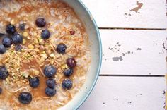 a bowl of oatmeal with blueberries and nuts