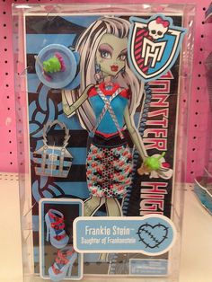 a barbie doll in a plastic box on a shelf