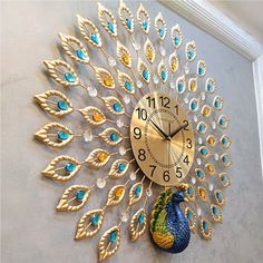 a clock that is on the side of a wall with a peacock face and feathers