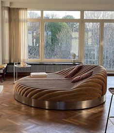 a living room filled with furniture and large windows