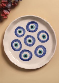 a white plate topped with blue and green eyeballs