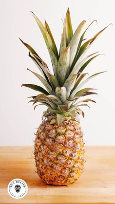 a pineapple sitting on top of a wooden table