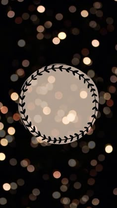 a baseball ball is in the middle of boket lights on a black background