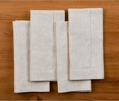 three pieces of linen folded on top of each other with stitching at the edges