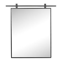 a mirror hanging on the wall with a black frame and metal bar around it's edge