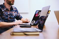 a man sitting in front of a laptop computer