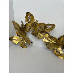 three metal butterflies sitting on top of each other