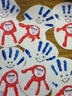 five handprints with the words thing 2 and three fingers painted on them, sitting on a table