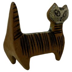 a ceramic cat figurine with black stripes on it's body and eyes