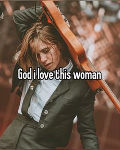 a woman holding a guitar and wearing a suit with the words god i love this woman