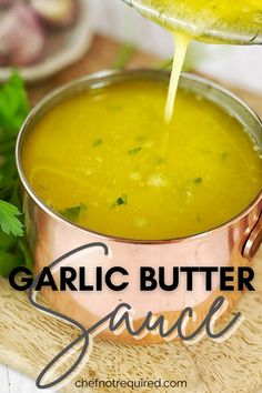 garlic butter sauce being poured into a pot on a cutting board with parsley in the background