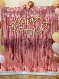 a pink and gold happy birthday backdrop with balloons