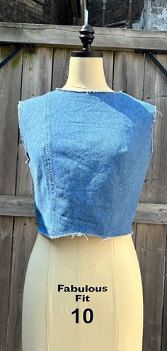 Upcycled vintage denim crop top made from recycled materials handmade in Canada. Raw hemm, neckline and shoulder. Metal hook and eye closure on the back. Cropped Cotton Denim Blue Vest, Cropped Denim Blue Cotton Vest, Fitted Cotton Cutoff Top, Cotton Denim Blue Crop Top, Denim Blue Cotton Crop Top, Denim Blue Cropped Cotton Crop Top, Stretch Cropped Top In Denim Blue, Denim Blue Crop Top, Stretch Denim Blue Cropped Crop Top