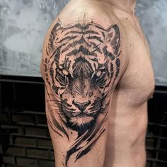 a man with a tiger tattoo on his arm