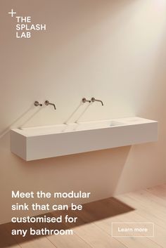 two white sinks sitting next to each other on top of a wooden floor in a bathroom