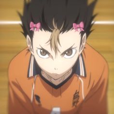 an anime character with black hair and pink bows on his head looking at the camera