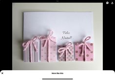 a greeting card with pink and white gift boxes