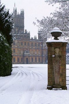 a clock tower in the middle of a snowy field