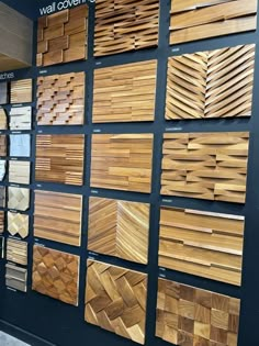 a wall covered in lots of different types of wood flooring tiles and boards on display