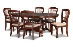 a dining room table with six chairs and one chair upholstered to the side