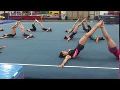 a group of people doing yoga exercises in a gym