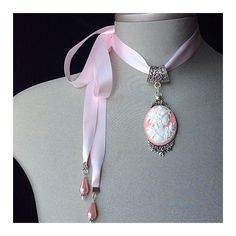 "Pink Cameo Choker! This beautiful, vintage inspired \"blush pink cameo\" is set in an antique silver pendant and attached to a blush pink satin ribbon This three dimensional, intricately detailed cameo has been securely set in a silver frame surrounded by tiny, antique silver roses The antique silver frame has been attached to an antique silver bale Added to the ends of the ribbon ties are 2 \"blush pink teardrop pearls\".... The perfect \"vintage inspired choker\" for the bride with a \"vintag Elegant Cameo Jewelry For Wedding, Elegant Cameo Necklaces For Wedding, Elegant Cameo Necklace For Wedding, Vintage Cameo Jewelry For Wedding, Pink Vintage Choker Jewelry, Elegant Pink Choker For Gift, Elegant Pink Choker As Gift, Feminine Wedding Jewelry Choker, Feminine Wedding Choker Jewelry