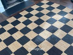 a black and white checkered rug in front of a fireplace