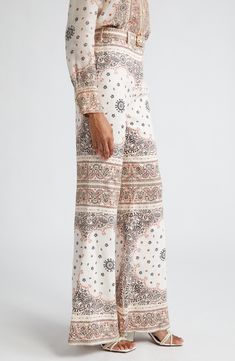 Breezy linen lends a lightness to the structured, flared silhouette of these belted high-waist pants covered in a placed bandana-inspired paisley print. 34 1/2 inseam; 30" leg opening; 12 1/2" front rise; 15 1/2" back rise (size 0) Hidden back-zip closure Removable belt 100% linen Dry clean Imported Designer Clothing Linen Wide Leg Pants, Wide Leg Linen Pants, Flared Pants, Printed Linen, Shearling Jacket, Swimwear Tops, Flare Pants, High Waisted Pants, Paisley Print