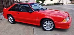 a red sports car parked in a parking lot