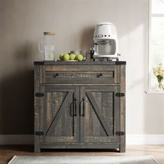 a kitchen cabinet with an open door and two green apples on top